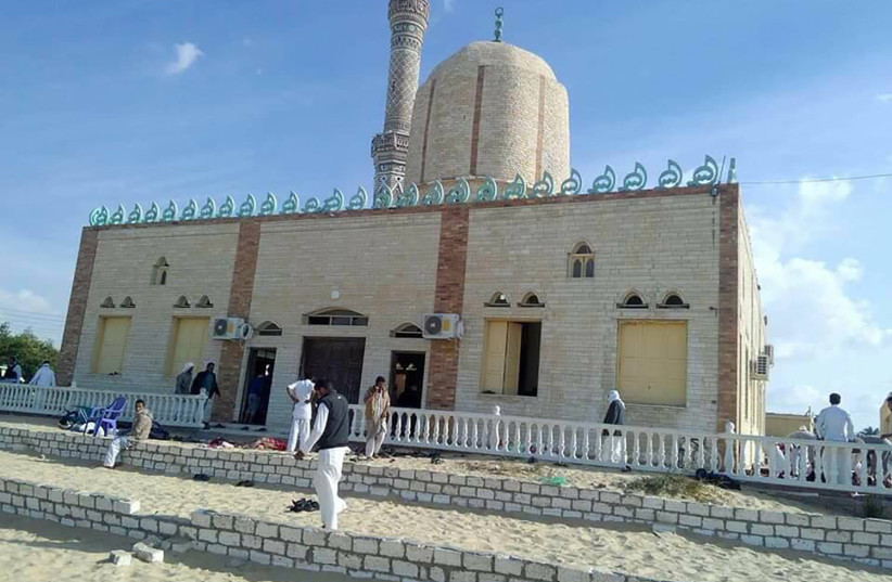 View of the Rawda mosque, roughly 40 kilometres west of the North Sinai capital of El-Arish, after a gun and bombing attack, on November 24, 2017. A bomb explosion ripped through the mosque before gunmen opened fire on the worshippers gathered for weekly Friday prayers, officials said. (credit: AFP PHOTO)