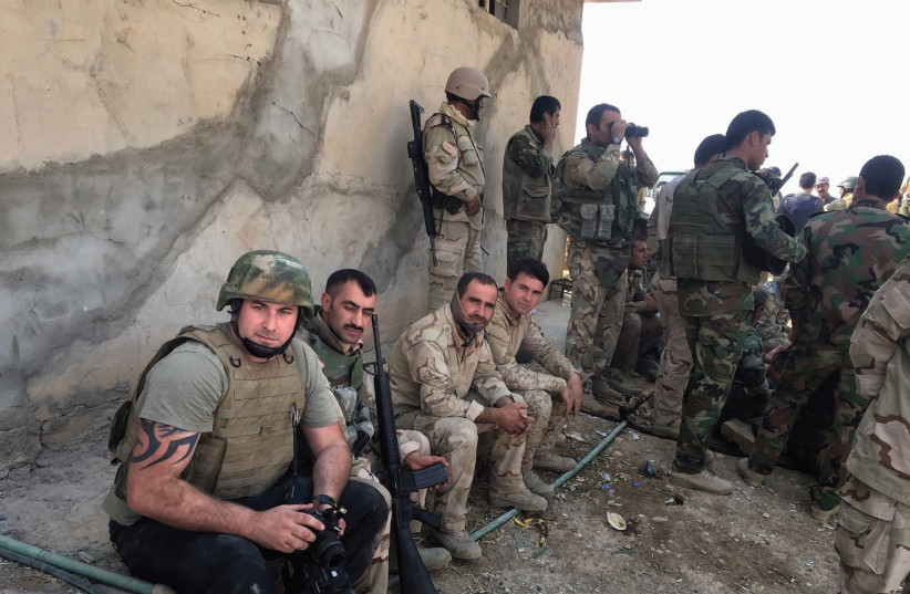 THE AUTHOR with Kurdish Peshmerga during the offensive near Bashiqa in October 2016. (photo credit: COURTESY EMILE GHESSEN)