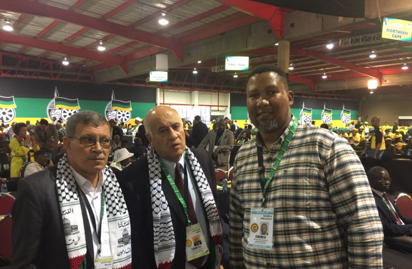 Members of the Palestinian Authority Majed Al-Fetyani and Jibril Rajoub pose with Nelson Mandela's grandson Mandla Mandela Saturday at the ANC National Conference in Johannesburg (photo credit: COURTESY ZAID NORDIEN)