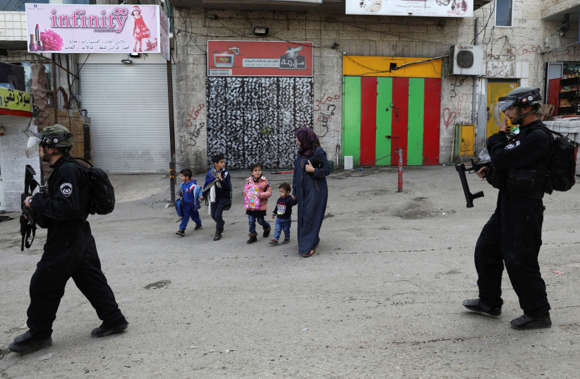Israeli policemen patrol a street in the East Jerusalem refugee camp of Shuafat (photo credit: REUTERS)