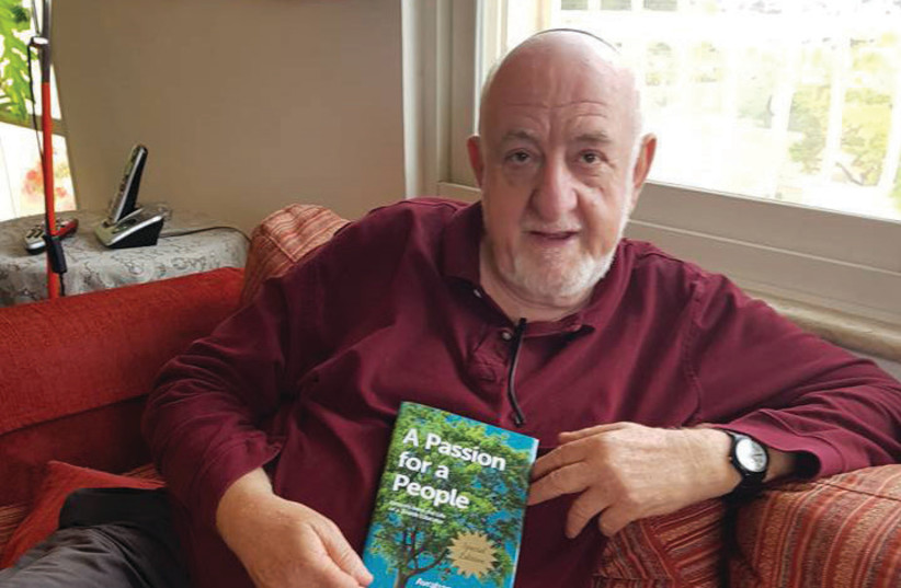 Avraham Infeld holds his new book at his home in Jerusalem (photo credit: STEVE LINDE)