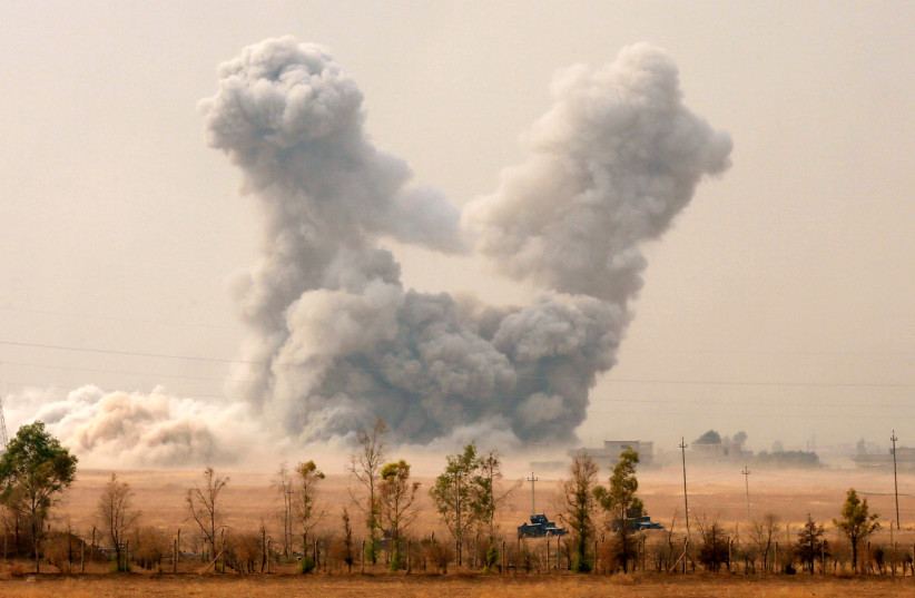 Smoke rises after an U.S. airstrike, while the Iraqi army pushes into Topzawa village during the operation against Islamic State militants near Bashiqa, near Mosul, Iraq October 24, 2016. (photo credit: AHMED JADALLAH / REUTERS)