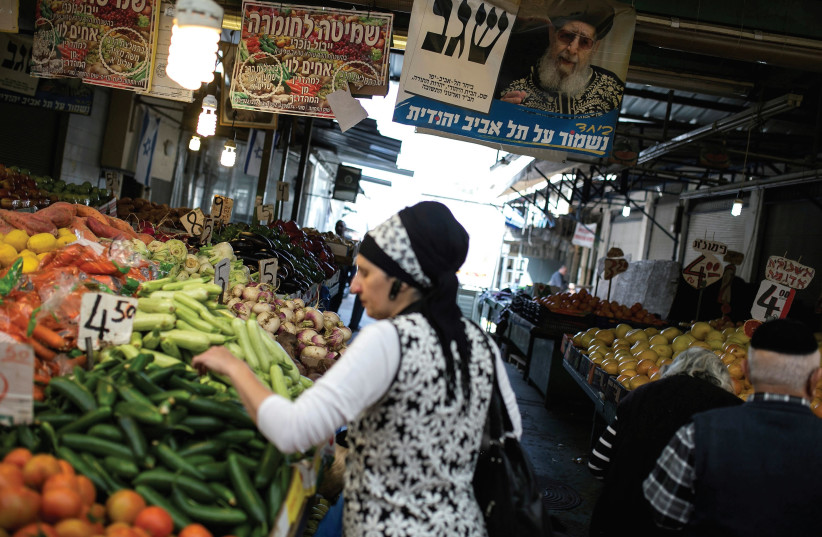 A WOMAN shops for vegetables at the Carmel market in Tel Aviv. (photo credit: REUTERS)