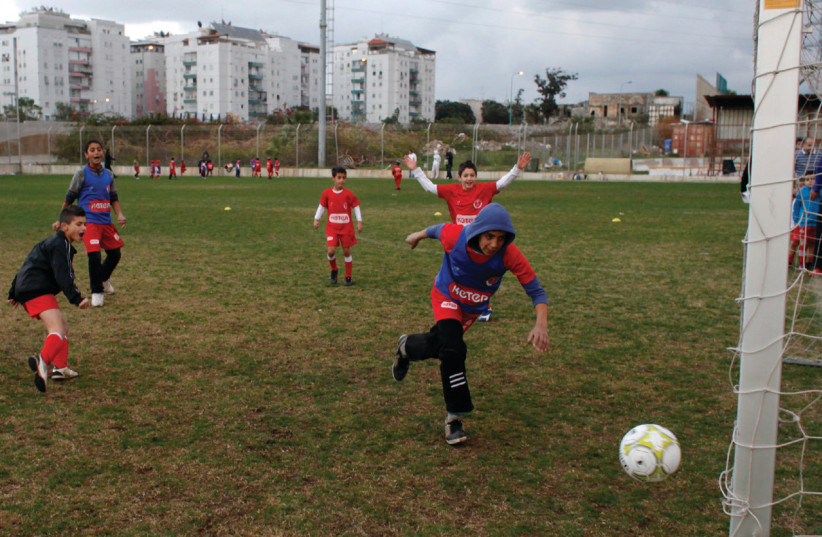 ARAB AND Jewish boys play soccer during a tournament to promote closeness, cooperation and coexistence in Holon in 2011 (photo credit: REUTERS/NIR ELIAS)