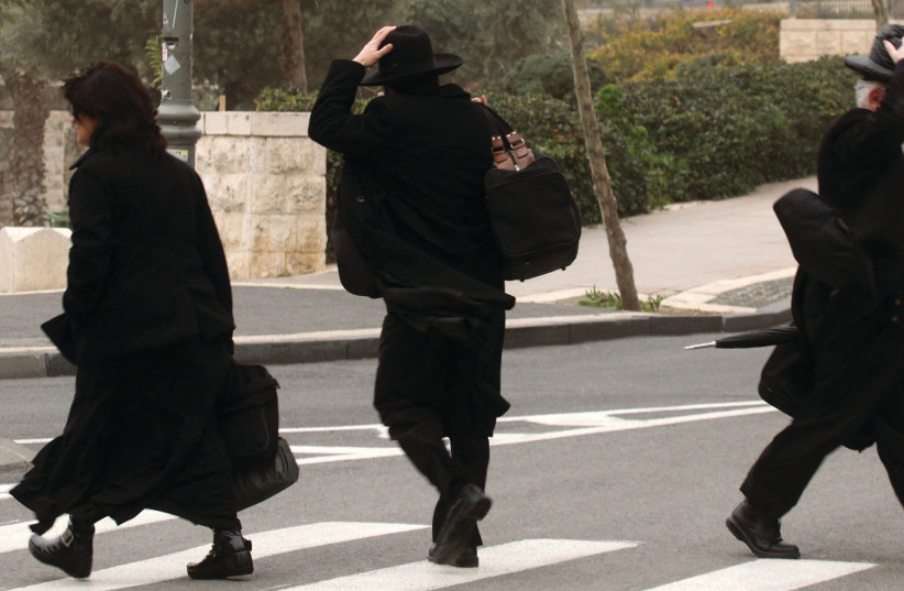 Haredi men hold on to their hats on a windy day in Jerusalem (photo credit: MARC ISRAEL SELLEM)