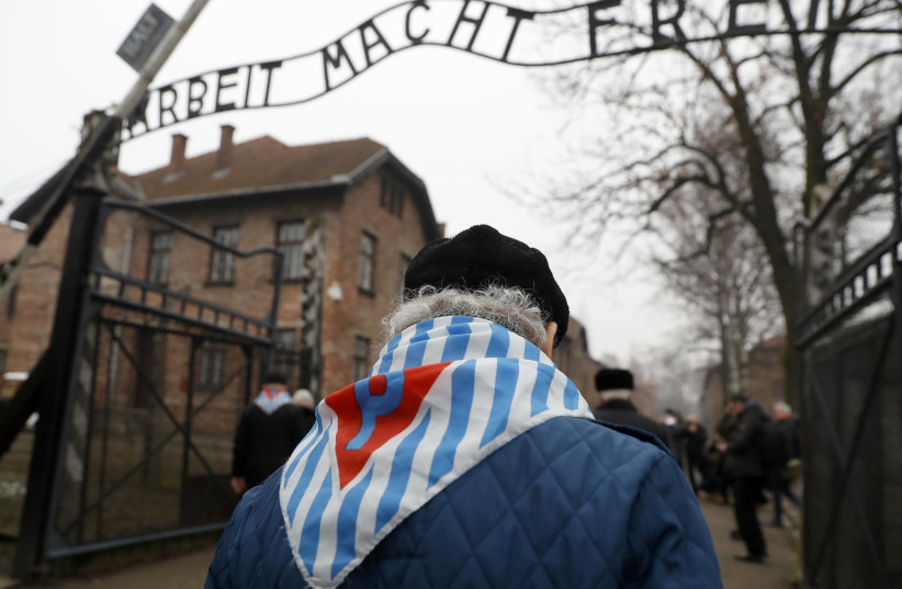 Holocaust survivors enter Auschwitz 73 years after its liberation on Holocaust Remembrance Day, January 2018 (credit: KACPER PEMPEL / REUTERS)