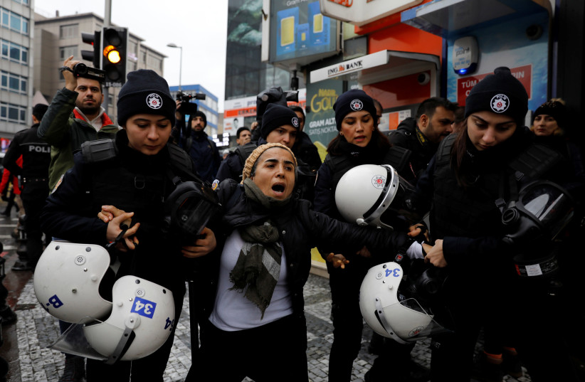 Riot police detain a demonstrator during a protest against Turkey's military operation in Syria's Afrin region, in Istanbul, Turkey (photo credit: UMIT BEKTAS / REUTERS)