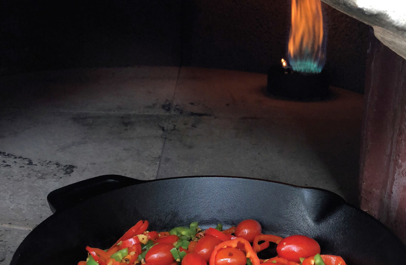 Tomatoes cooked on a skillet in a taboun. (photo credit: PASCALE PEREZ-RUBIN)