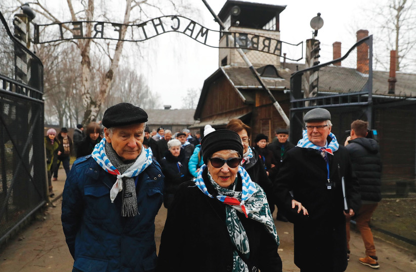 HOLOCAUST SURVIVORS visit the site of the Auschwitz death camp, during ceremonies marking the 73rd anniversary of the camp’s liberation and International Holocaust Victims Remembrance Day, in Poland in January 2018.. (photo credit: KACPER PEMPEL / REUTERS)