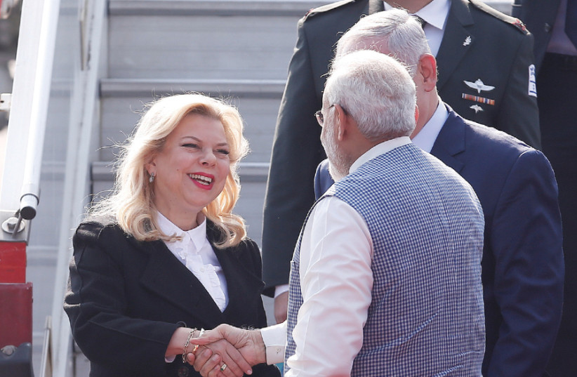 SARA NETANYAHU shakes hands with India’s Prime Minister Narendra Modi as Prime Minister Benjamin Netanyahu looks on, in New Delhi January 2018 (photo credit: ADNAN ABIDI/ REUTERS)
