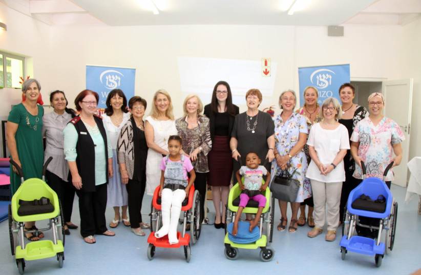 Members of WIZO South Africa, Israeli NGO Wheelchairs of Hope and the Israeli Embassy pose with nurses and disabled children at Maitland Cottage Children’s Orthopaedic Hospital in Cape Town (photo credit: COURTESY WIZO)