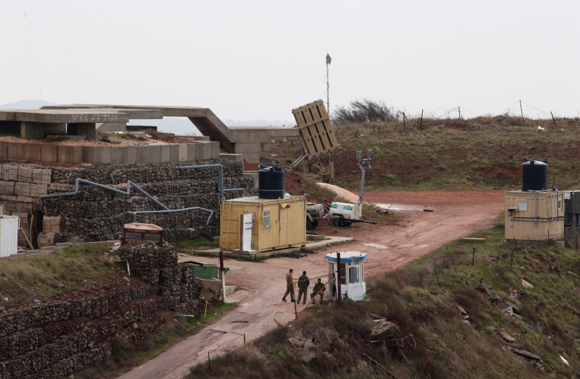 Israeli soldiers walk next to an anti-missile battery at a military post near the Druze village of Majdal Shams in the Golan Heights, Israel February, 2018  (photo credit: AMMAR AWAD / REUTERS)