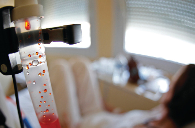 A PATIENT receives chemotherapy treatment  (photo credit: REUTERS/ERIC GAILLARD)