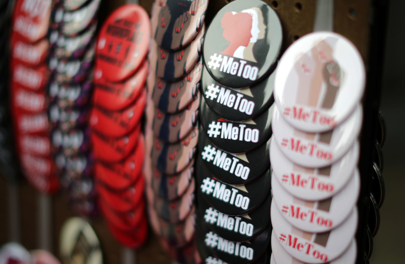A vendor sells #MeToo badges a protest march for survivors of sexual assault and their supporters in Hollywood, Los Angeles, California US (photo credit: LUCY NICHOLSON / REUTERS)