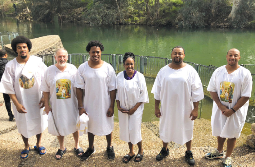 CHRISTIANS, including NFL players (from left) Vic Beasley, Avery Williamson and Chris Harris Jr., prepare to be baptized at Yardenit on the Jordan River (photo credit: COURTNEY FALLON/AMERICA’S VOICES IN ISRAEL)
