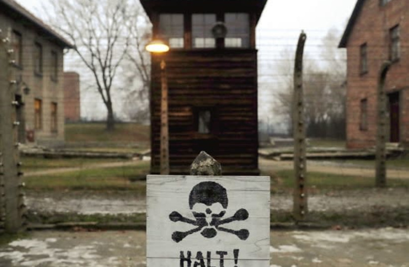 A sign in German and Polish is seen at Auschwitz (photo credit: REUTERS)