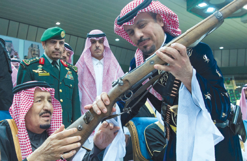 SAUDI ARABIA’S King Salman bin Abdulaziz Al Saud (left) attends a ceremony of the traditional Ardha sword dance as part of the activities of Janadriyah Culture festival, in Riyadh, last month (photo credit: REUTERS)