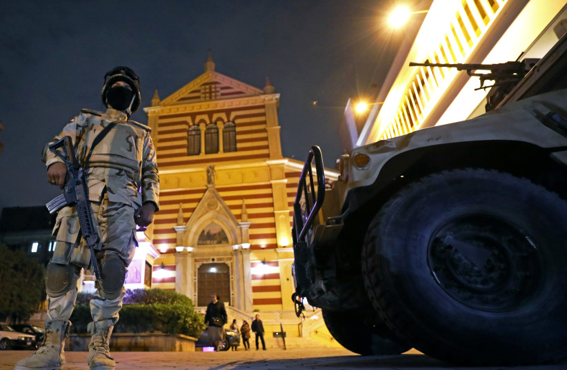 Egyptian army soldiers stand guard during a New Year's Eve mass at Saint Joseph's Roman Catholic Church in Cairo, Egypt December 31, 2017. (photo credit: REUTERS/MOHAMED ABD EL GHANY)