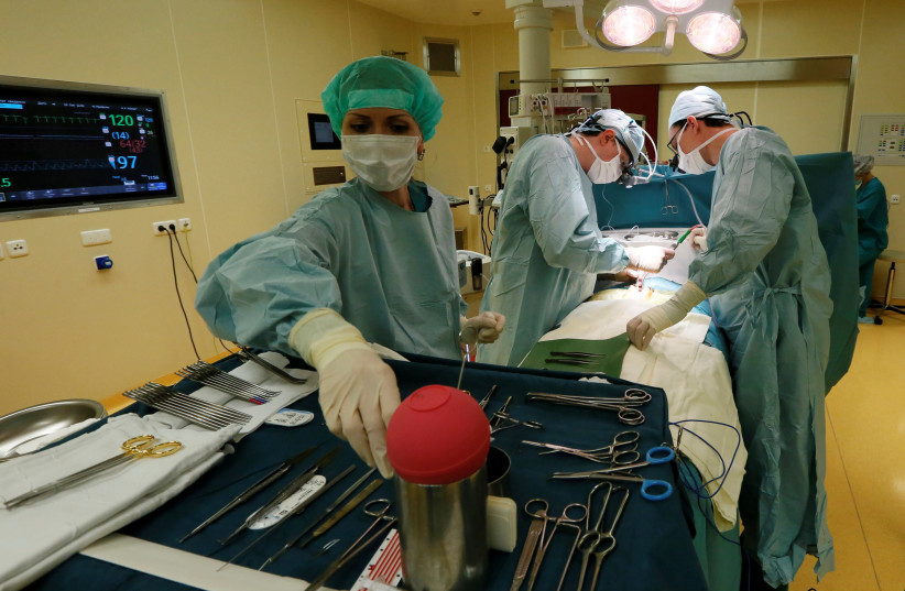 File photo: Heart surgeons perform an operation (photo credit: REUTERS)