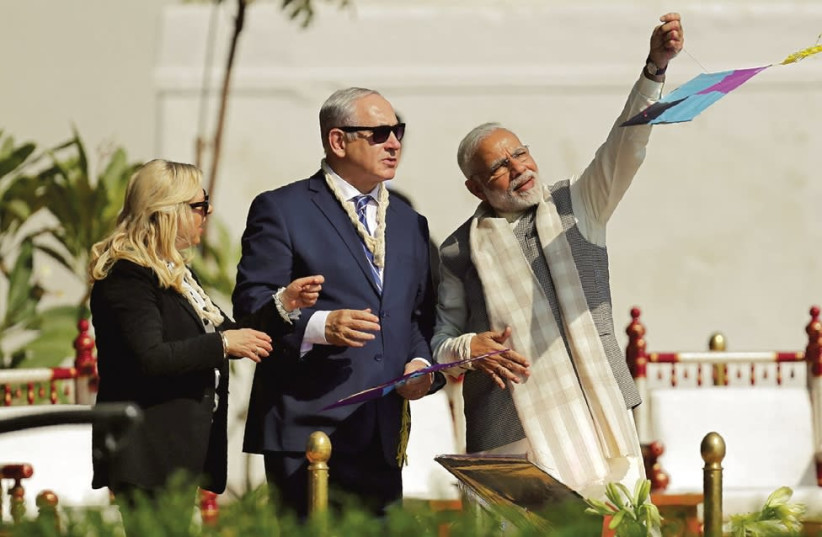 Prime Minister Benjamin Netanyahu and his wife, Sara, watch as Indian Prime Minister Narendra Modi flies a kite in Ahmedabad in January (photo credit: REUTERS/AMIT DAVE)