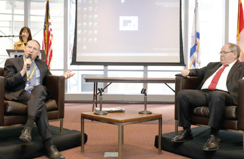 RABBI YEHOSHUA FASS (left), cofounder and executive director of Nefesh B’Nefesh, speaks with Israel’s Consul General in New York, Dani Dayan, at the organization’s Mega Event (photo credit: SHAHAR AZRAN)