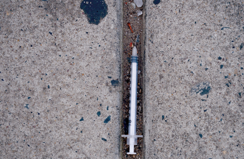 A NEEDLE used for shooting heroin and other opioids litters the ground in Philadelphia last year. The effect of many opioids can be made stronger through injection (credit: REUTERS/CHARLES MOSTOLLER)