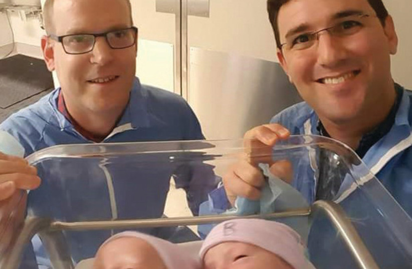 RA’ANANA’S NEWLY elected mayor Eitan Ginzburg (right), and his partner, Yotam Nisenboat, pose with their children last year in the US (photo credit: Courtesy)