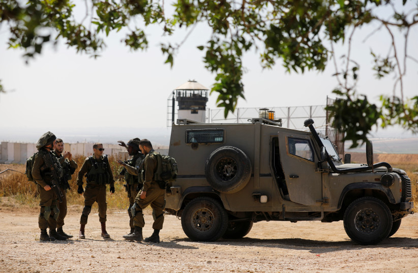 Israeli soldiers deploy on the Israeli side of the border with the northern Gaza Strip, April 1, 2018. (photo credit: REUTERS/AMIR COHEN)