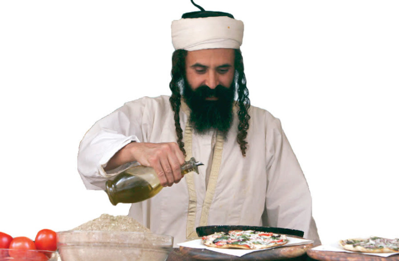 AN ULTRA-ORTHODOX man adds olive oil to pizza before serving it to customers in his restaurant in Safed in 2010 (photo credit: NIR ELIAS / REUTERS)