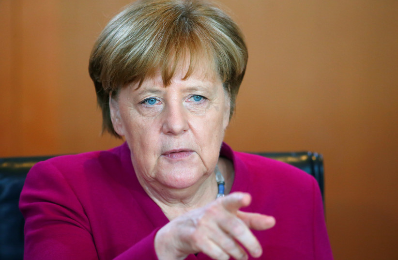 Angela Merkel gestures during a cabinet meeting in Berlin (photo credit: HANNIBAL HANSCHKE/REUTERS)