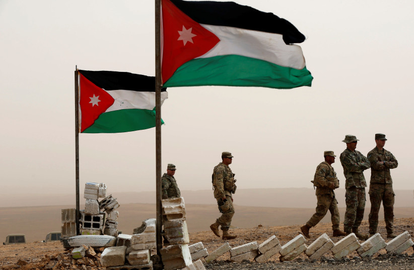 US soldiers stand next to Jordanian flags as they take part in Exercise Eager Lion at one of the Jordanian military bases in Azraq, east of Amman, Jordan, April 26, 2018 (photo credit: MUHAMMAD HAMED/REUTERS)