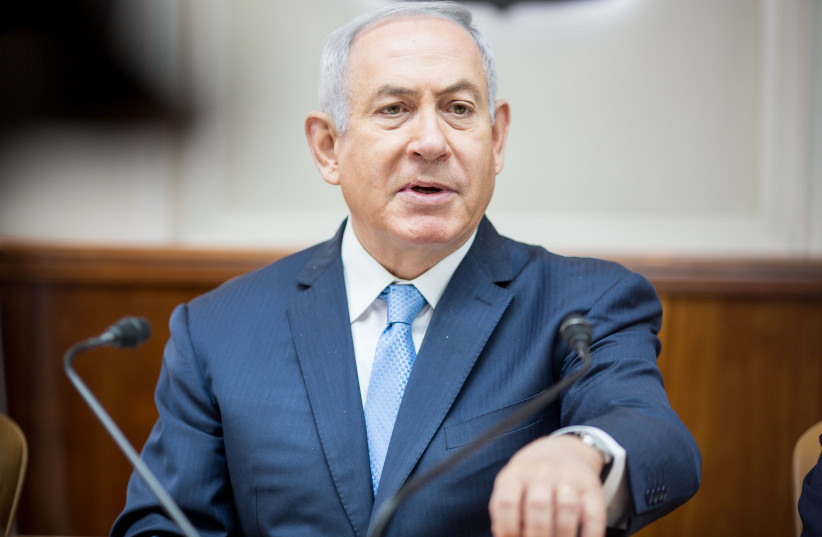 Prime Minister Benjamin Netanyahu speaks at a weekly cabinet meeting in May 2018. (photo credit: EMIL SALMAN/POOL)