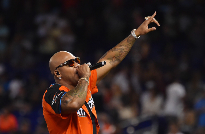 Recording artist Flo Rida performs before the MLB legends and celebrity softball game at Marlins Park (photo credit: JASEN VINLOVE-USA TODAY SPORTS / VIA REUTERS)
