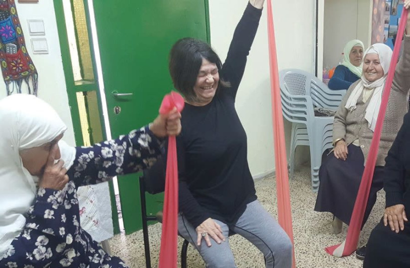 Miriam Wrobel leads women in exercise – and learning the value of keeping their muscles and joints flexible (photo credit: SABAH YOUNIS)