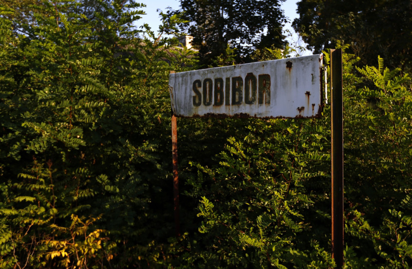A rusty road sign is seen outside the perimeter of a Nazi death camp in Sobibor September 18, 2014. An archaeological dig, which has been carried out since 2007, has recently revealed the location of gas chambers under a road at the Sobibor death camp, the Yad Vashem International Institute for Holo (photo credit: KACPER PEMPEL / REUTERS)