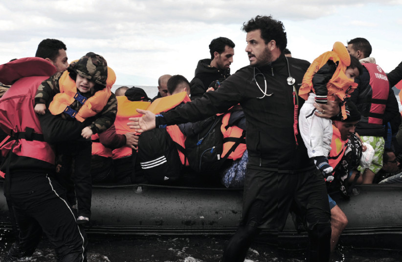 Dr. Essam Daod in the Greek island of Lesvos during a rescue of a Syrian refugee boat, October 2015 (photo credit: MATIAS QUIRNO COSTA)