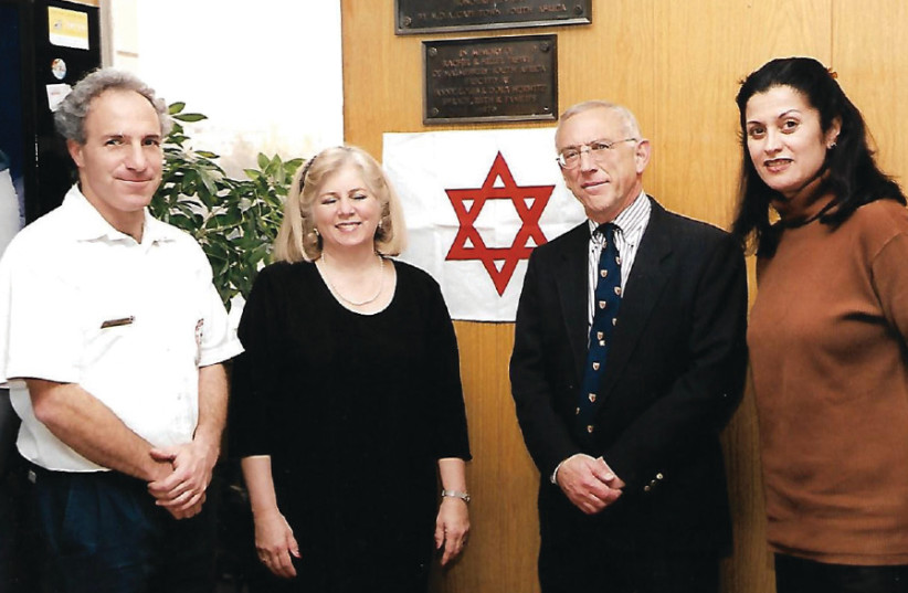 A ceremony for unveiling the plaque for Ephraim Charlaff in 2002: (from left) Yonatan Yagodovsky, director of the Jerusalem station at the time, Tobey Yanai Charlap and her husband, Joe Charlaff, and Rina Amikam, head of MDA public relations (photo credit: MAGEN DAVID ADOM)