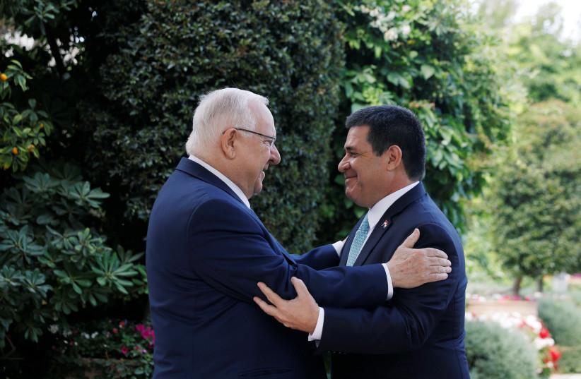 Israeli President Reuven Rivlin embraces Paraguayan President Horacio Cartes upon his arrival for a meeting at his residence in Jerusalem, ahead of the dedication ceremony of the embassy of Paraguay in Jerusalem, May 21, 2018 (photo credit: RONEN ZVULUN / REUTERS)