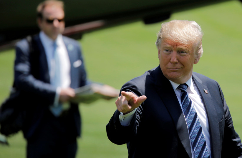 US President Donald Trump gesticulates as he returns from a trip to trip to Annapolis, Maryland, in Washington, US, May 25, 2018. (photo credit: REUTERS/CARLOS BARRIA)