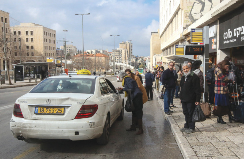 A taxi driver collects a passenger near the Jerusalem Bus Station (photo credit: MARC ISRAEL SELLEM)