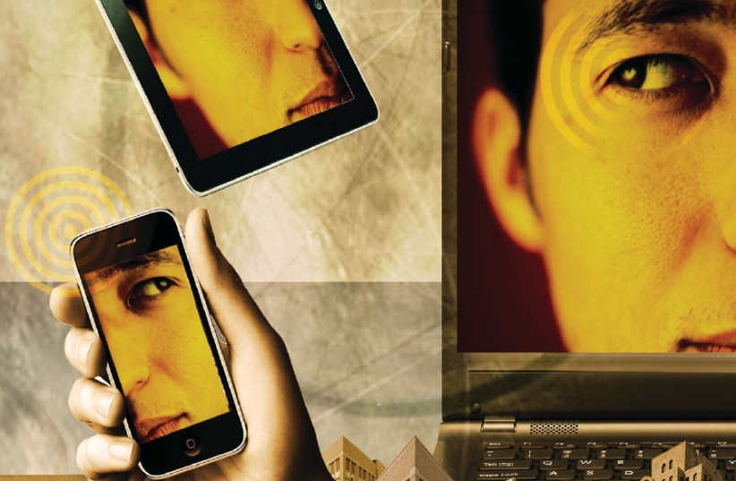 Illustrative photo: a man sees his face on multiple smart devices (photo credit: TNS)
