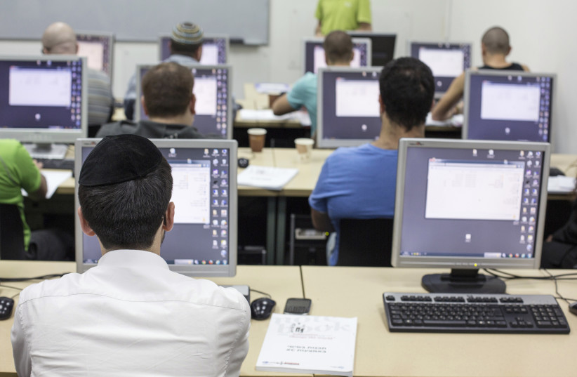 An ultra-Orthodox Jewish man attends a computer course at a technical college in Jerusalem October 16, 2013. (photo credit: REUTERS/BAZ RATNER)