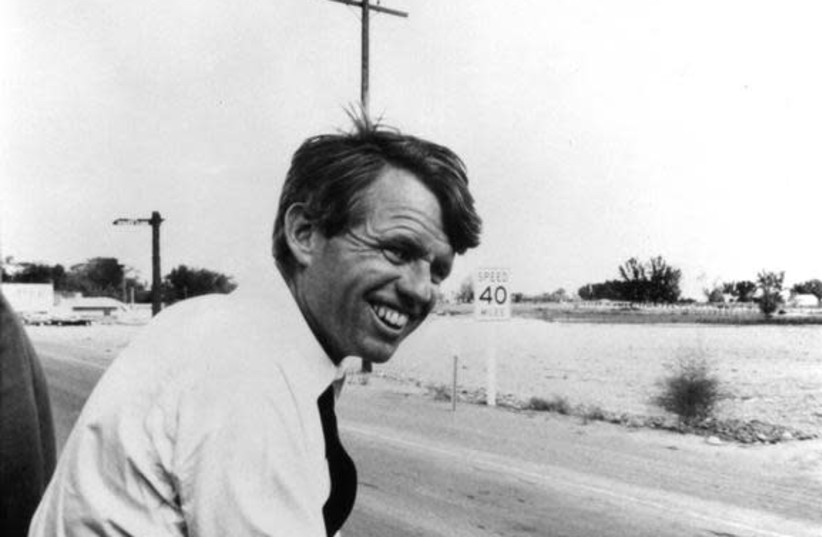 Robert F. Kennedy sits alongside the motorcade in this 1968 file photograph. (credit: REUTERS/STRINGER)