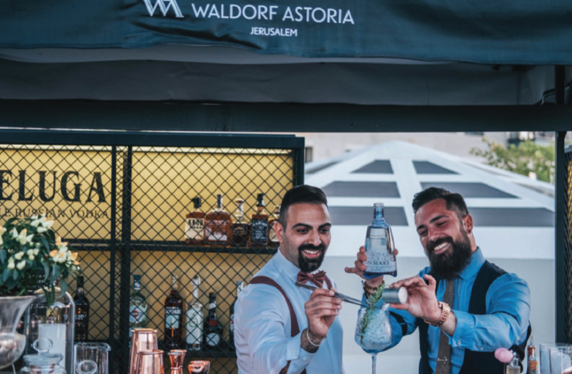 Gin Mare ambassador Ezio Canetti from Barcelona (right) and the hotel’s chief mixologist Issa Amar at the Garden Terrace on the opening night (photo credit: WALDORF ASTORIA JERUSALEM)