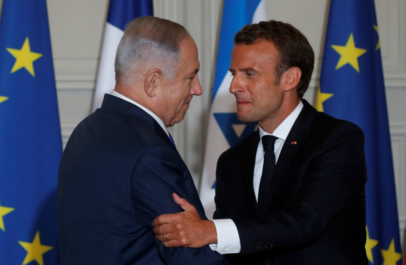 French President Emmanuel Macron and Israeli Prime Minister Benjamin Netanyahu shake hands as they attend a joint press conference at the Elysee Palace in Paris, France, June 5, 2018.  (photo credit: PHILIPPE WOJAZER / REUTERS)