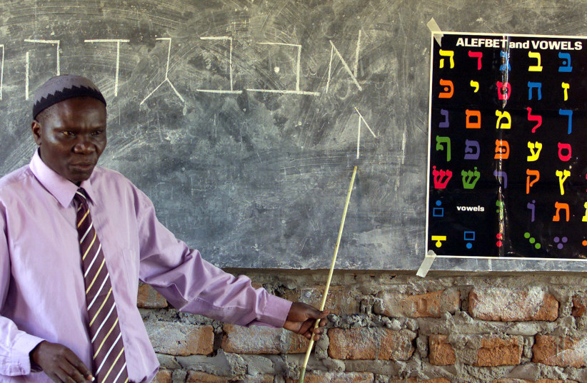 Ugandan Rabbi Harun Kintu Moses conducts a Hebrew language lesson at Hadassah School, a jewish community institute in Mbale some 224km east of Uganda's capital Kampala. Ugandan Rabbi Harun Kintu Moses conducts a Hebrew language lesson at Hadassah School, a Jewish community institute in Mbale along t (photo credit: REUTERS)
