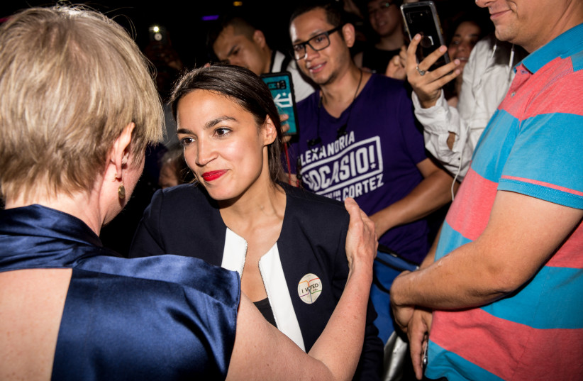Progressive challenger Alexandria Ocasio-Cortez embraces New York gubenatorial candidate Cynthia Nixon at her victory party in the Bronx after upsetting incumbent Democratic Representative Joseph Crowly on June 26, 2018 (photo credit: SCOTT HEINS/GETTY IMAGES/AFP)