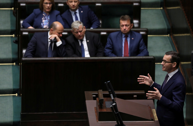  Poland’s Prime Minister Mateusz Morawiecki speaks during a debate about the controversial Holocaust bill in the lower house of parliament in Warsaw on Wednesday.  (photo credit: REUTERS)