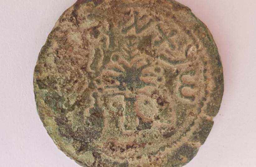 A bronze coin from the fourth year of the Great Revolt discovered in the City of David, July 2018 (photo credit: ARCHAEOLOGICAL EXPERIENCE - CITY OF DAVID AT EMEK ZURIM NATIONAL PARK)