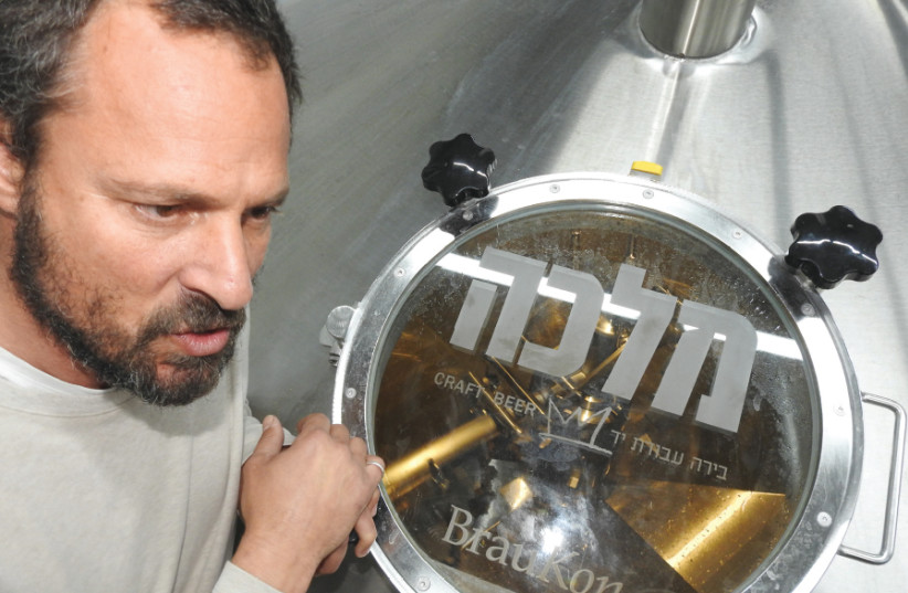 ASSAF LAVI inspects the brewing kettle in the new Malka Brewery in Tefen (photo credit: MIKE HORTON)